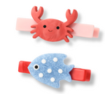 Lillies & Roses Ocean Friends Crab Hair Clips feature two handmade clips: one showcasing a red smiling crab and the other a blue fish with charming white spots. Both clips have rectangular bases, making these adorable accessories perfect for ocean-loving friends and sea-themed styles.