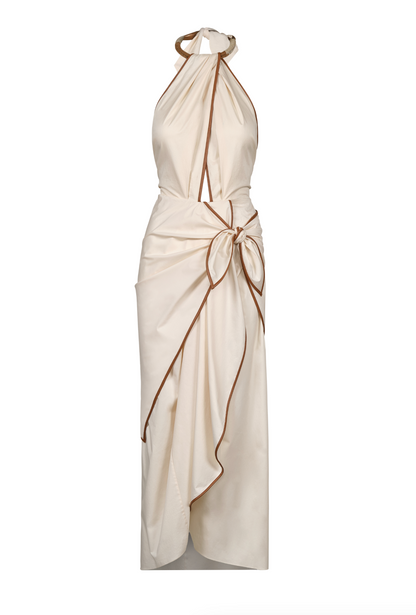 The Centro Del Cielo Ankle Dress by Johanna Ortiz is a sleeveless cream halter-neck dress with brown trim, a draped front, and a side bow at the waist—ideal for intimate gatherings seeking quiet luxury.