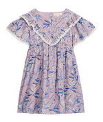 The Girls’ Siloe Dress by Louise Misha is a short-sleeve, knee-length cotton dress featuring a pink and blue floral print, a ruffled lace-trimmed collar, gathered waist, and delicate lace edges.