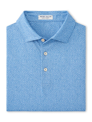 A Peter Millar Bristol Floral Performance Jersey Polo, folded in light blue with a small white floral pattern, three buttons, and UPF 50+ performance jersey fabric.