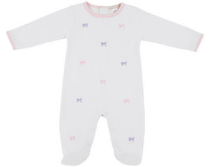 The Beaufort Bonnet Company Baby Girls' Rock Me Romper: white onesie with long sleeves, pink trim, and scattered pink and purple bow patterns, shown on a plain background.