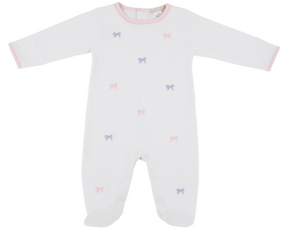 The Beaufort Bonnet Company Baby Girls' Rock Me Romper: white onesie with long sleeves, pink trim, and scattered pink and purple bow patterns, shown on a plain background.