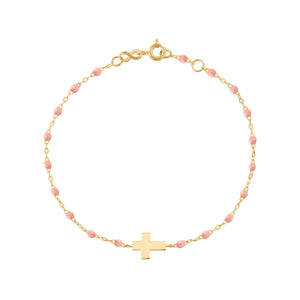 The Gigi Clozeau Little Gigi Classic Cross Charm Bracelet 5.1" features an 18k gold chain with pink resin pearls and a central gold cross charm, beautifully displayed on a white background.
