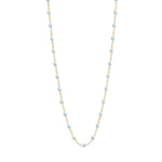 The Gigi Clozeau Classic Gigi Necklace, 16.5" is displayed on a delicate gold chain.