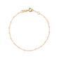 The Classic Gigi Bracelet 6.7" by Gigi Clozeau showcases an elegant design with a delicate thin 18 carat yellow gold chain, small pink beads, and a secure clasp closure, embodying timeless style.