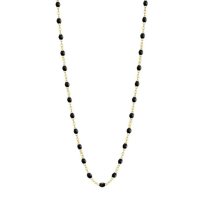The Classic Gigi Necklace 16.5" by Gigi Clozeau is a stunning piece crafted in 18 carat yellow gold, featuring small black beads elegantly spaced along the chain.
