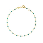 A Gigi Clozeau Classic Gigi bracelet in 18 carat Yellow Gold with emerald gemstones, displayed against a white background with the word "emerald" beneath it.