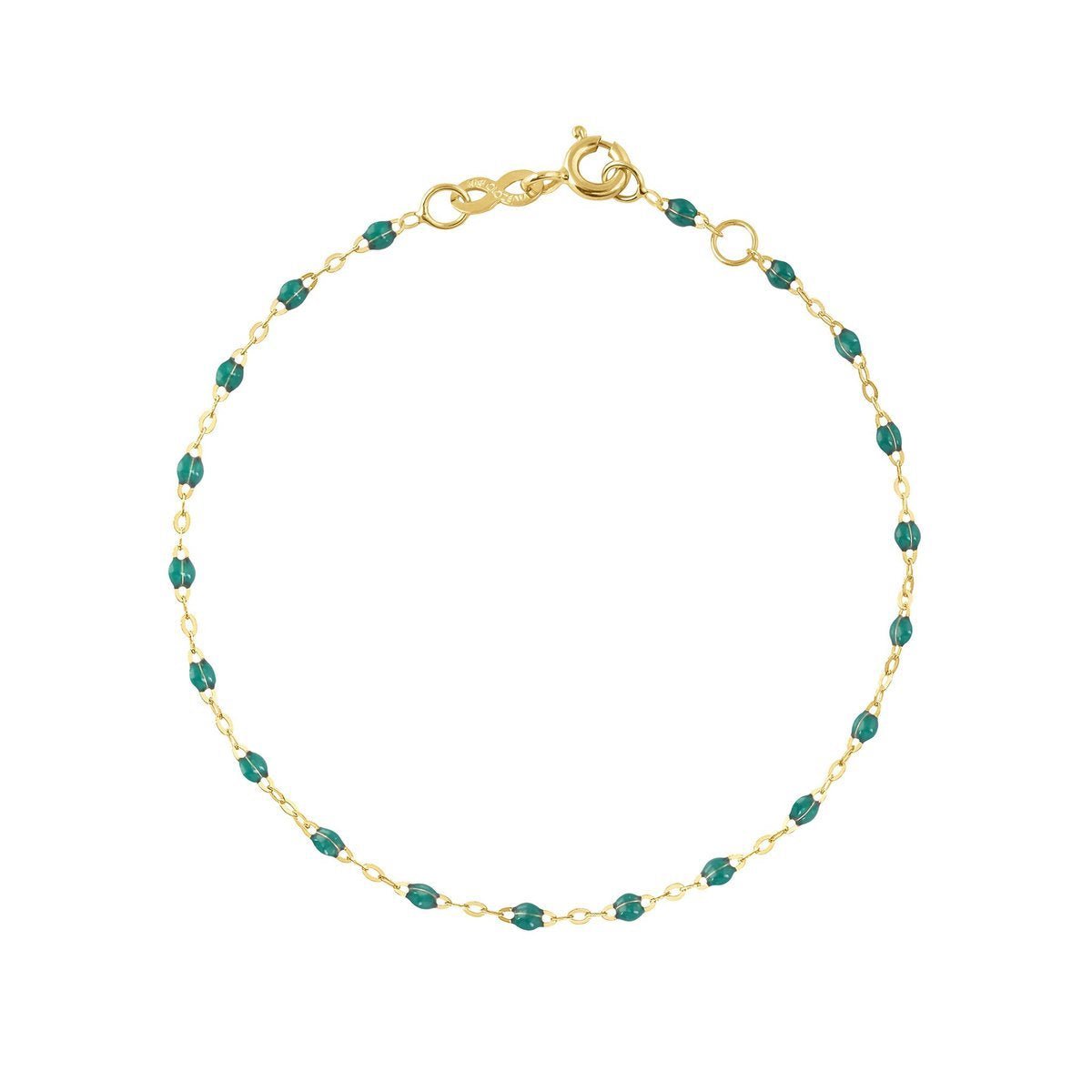 A Gigi Clozeau Classic Gigi bracelet in 18 carat Yellow Gold with emerald gemstones, displayed against a white background with the word "emerald" beneath it.