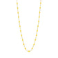 The Classic Gigi Necklace 16.5" by Gigi Clozeau is crafted in 18-carat yellow gold with evenly spaced small yellow beads, beautifully displayed on a white background.
