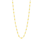 The Classic Gigi Necklace 16.5" by Gigi Clozeau is crafted in 18-carat yellow gold with evenly spaced small yellow beads, beautifully displayed on a white background.