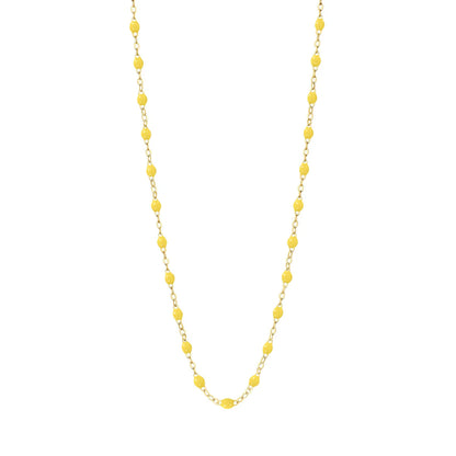 The Classic Gigi Necklace 16.5" by Gigi Clozeau is crafted in 18-carat yellow gold with evenly spaced small yellow beads, beautifully displayed on a white background.