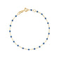 The Classic Gigi Bracelet 6.7" by Gigi Clozeau is crafted in 18k yellow gold with small blue beads and an adjustable spring ring clasp—perfect as versatile everyday jewelry.