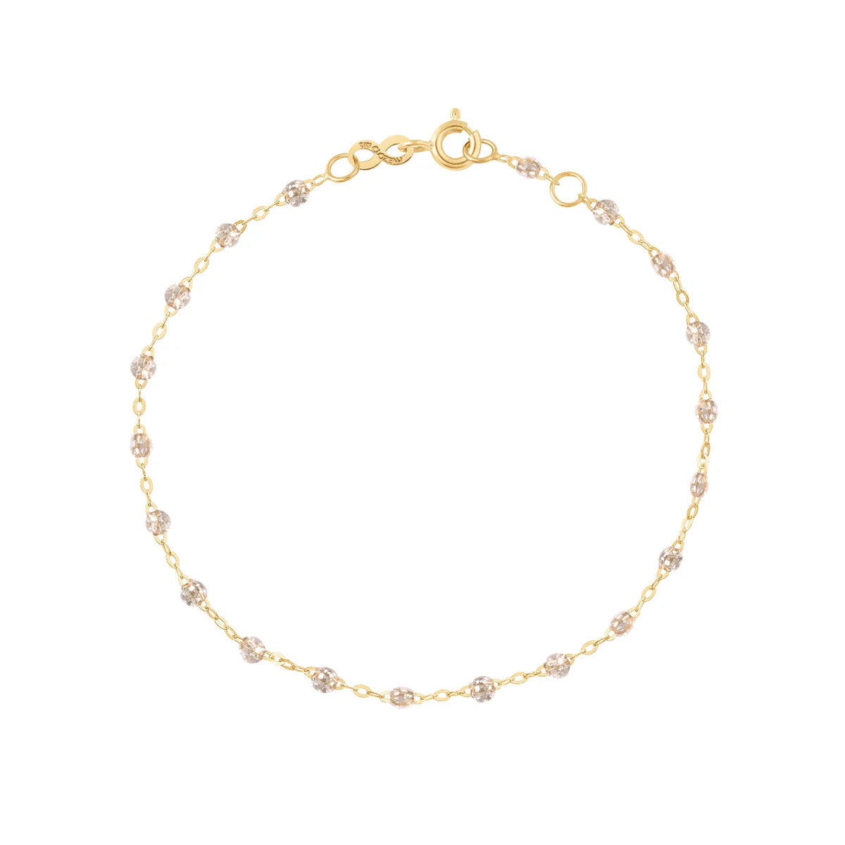 The Gigi Clozeau Classic Gigi Bracelet 6.7" is a delicate 18 carat yellow gold piece with evenly spaced small beads and a round clasp, ideal for easy, everyday elegance.