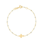 The Gigi Clozeau Classic Cross Charm Bracelet 6.7" features elegant resin pearls, a central cross charm, 18 carat gold craftsmanship, and an adjustable clasp.