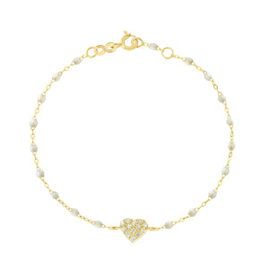 The In Love Diamond Bracelet 6.7" by Gigi Clozeau features a gold chain with small black resin pearls and a central heart pendant adorned with clear stones, crafted in 18k yellow gold, shown on a white background.