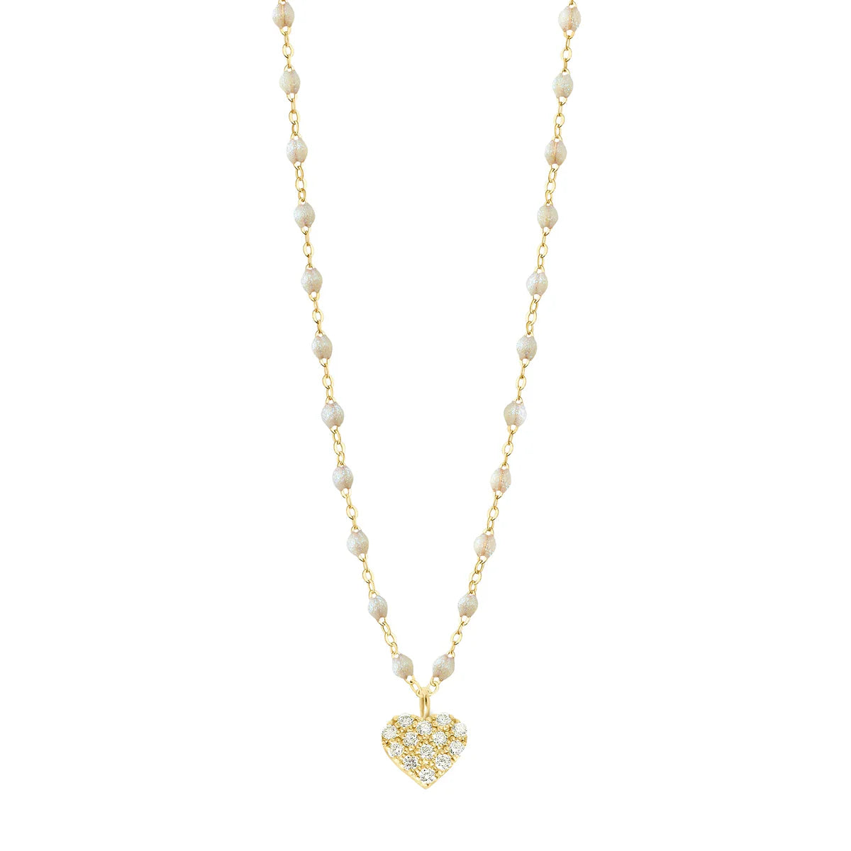 The Gigi Clozeau In Love Diamond Necklace 16.5" features yellow gold with small white opal resin pearls and a heart pendant studded with clear stones, elegantly displayed on a plain white background.