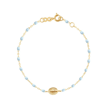 The Gigi Clozeau Madone Charm Bracelet 6.7" features alternating small blue resin pearls, a central 18k gold medallion, and a lobster clasp closure.