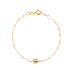 The Gigi Clozeau Madone Charm Bracelet 6.7" is crafted in 18k gold with small pink beads, an oval charm centerpiece, and a secure lobster clasp.