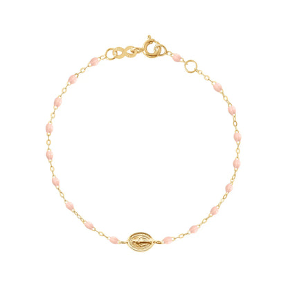 The Gigi Clozeau Madone Charm Bracelet 6.7" is crafted in 18k gold with small pink beads, an oval charm centerpiece, and a secure lobster clasp.
