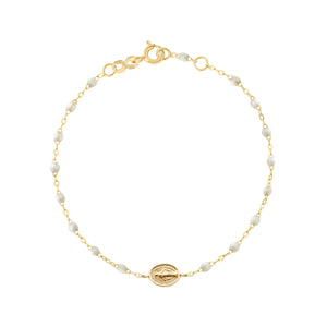 The Madone Charm Bracelet 6.7" by Gigi Clozeau is crafted in 18k gold with refined resin pearls, an oval medallion charm, lobster clasp, and adjustable links.