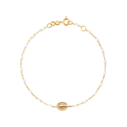 The Madone Charm Bracelet 6.7" by Gigi Clozeau features elegant resin pearls, a round medallion charm, and is crafted from 18k gold with a secure lobster clasp.