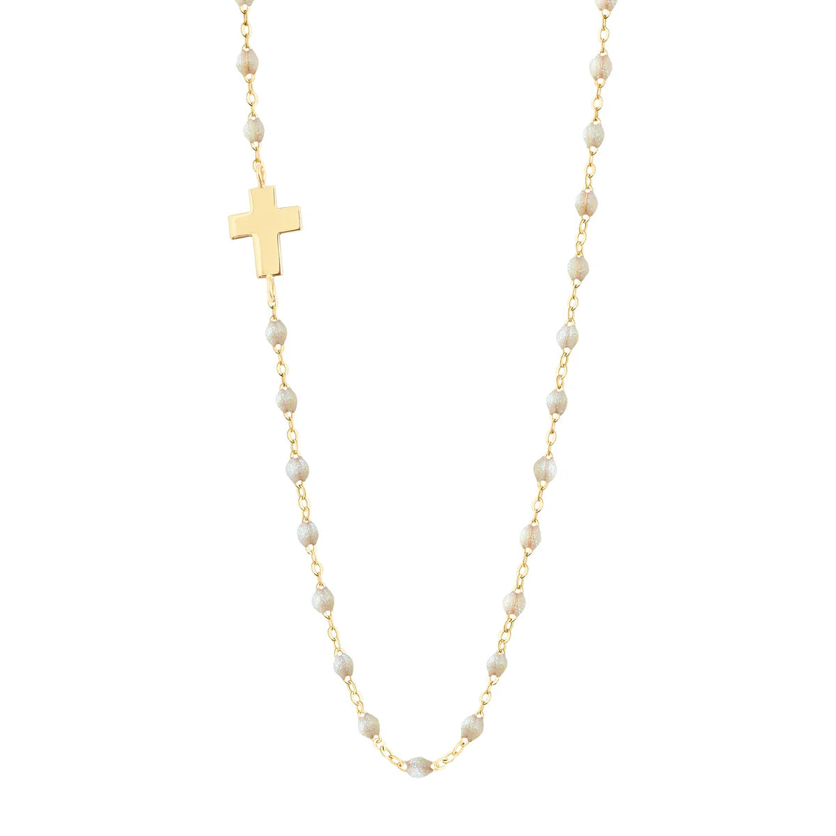 The Gigi Clozeau Side Cross Necklace 16.5" features small resin pearls and a flat gold cross pendant elegantly set to the left for a unique look.