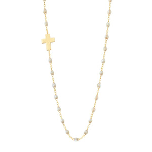 The Gigi Clozeau Side Cross Necklace 16.5" features small resin pearls and a flat gold cross pendant elegantly set to the left for a unique look.