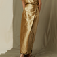Against a beige backdrop, a person wears the Ann Mashburn Renata Silk Shantung Wrap Skirt with a matching sleeveless top and sandals. Their head and feet are partially cropped from the frame.