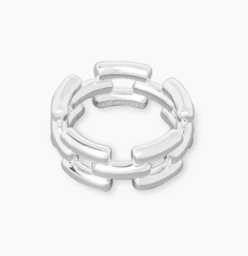 The Isabel Ring by Lie Studio is a timeless piece with a geometric, interlocking segmented design, shown on a plain white background.
