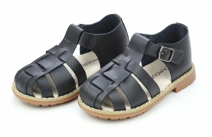 L'Amour Shoes' Boys' Aiden Fisherman Sandal features black woven waxed leather straps, secure ankle buckle closures, and tan rubber soles for a simple, versatile look.