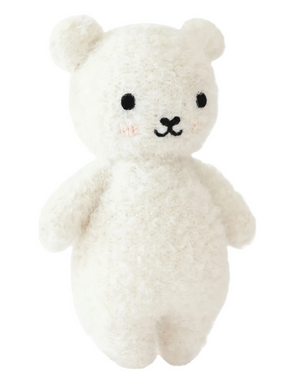 The Ivory Boucle Bear - Baby 7" by Cuddle + Kind is a plush white teddy bear featuring small black eyes, a stitched nose and mouth, blushed cheeks, round ears, and a soft, textured surface—crafted from heirloom-quality Peruvian cotton yarn for lasting comfort and charm.