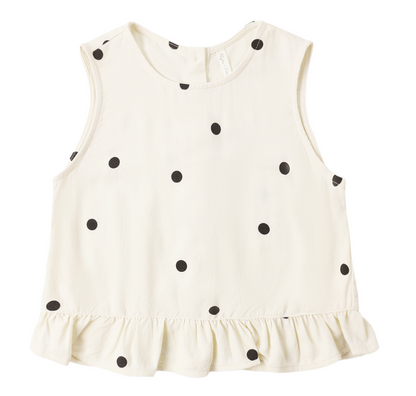 The Girls' Oceanside Top by Rylee & Cru is a sleeveless white cotton top for toddlers, featuring black polka dots and a charming ruffle detail at the hem, displayed on a plain white background.