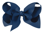 Introducing the Milledeux® Large Boutique Bow featuring an alligator clip, a handmade masterpiece crafted with textured fabric and wide loops in a stunning blue hue, perfect for adding a touch of elegance to any hairstyle.