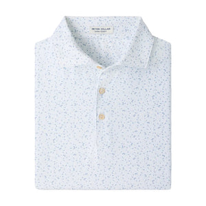 The Peter Millar On The Line Performance Jersey Polo is a neatly folded white polo shirt featuring a subtle blue floral pattern and three light-colored buttons, crafted with four-way stretch for all-day comfort.