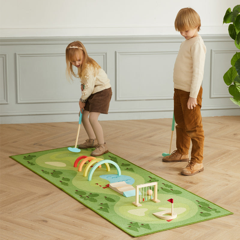 Two children practicing putting on a Asweets Good Golf Mat.