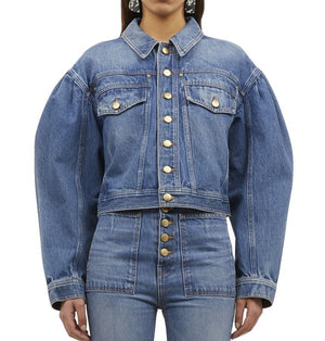 Person wearing a blue Ulla Johnson Cosette Jacket with gold buttons and matching high-waisted premium denim blue jeans.