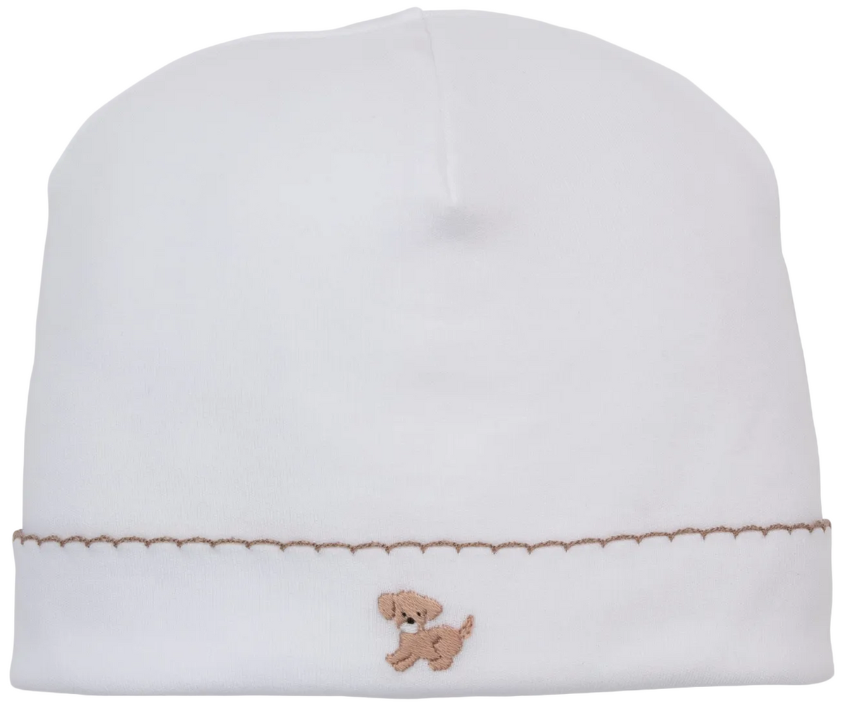 The Kissy Kissy Premier Puppy Paws Hand Emb. Hat is a white baby hat made from soft Peruvian cotton, adorned with a delicate hand-embroidered brown dog and a decorative brown stitched line near the brim.