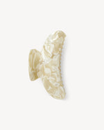 The Machete Grande Heirloom Claw is a cream marbled hair clip, handcrafted from Italian acetate with a textured, glossy finish and double-walled construction, shown on a plain white background.