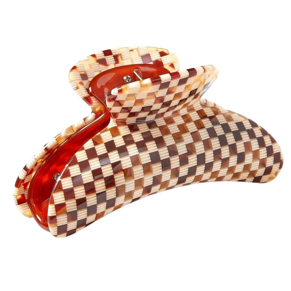 A Machete Grande Heirloom Claw check-patterned Italian acetate hair claw clip with shades of brown and orange, isolated on a white background.