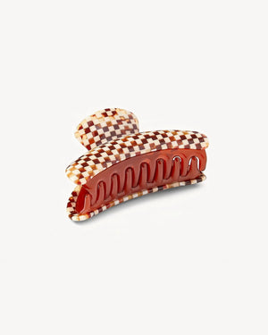 The Machete Grande Heirloom Claw is a large hair clip crafted from premium Italian acetate, featuring a chic checkerboard pattern in brown, beige, and cream hues. Designed with interlocking teeth and a gracefully curved shape, this stylish accessory is ideal for securing long, thick hair. Shown against a plain white background.