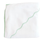 The Terry Tots Kids’ Scalloped Hooded Towel, featuring a white design with green wavy trim, is displayed folded against a plain white background—a perfect nursery essential for your little one.