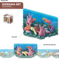 A Halftoys Ocean Friends diorama set featuring a colorful underwater scene with fish, coral, and a turtle. The packaging indicates it's easy to build and can be linked with other Ocean Friends dioramas by Halftoys. A sample box is shown on the side.