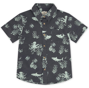 Crafted sustainably from recycled coconut-polyester, the Feather 4 Arrow Boys’ Button Down Shirt showcases a lively sea life print—featuring sharks, octopuses, fish, and coral—set against a dark background.