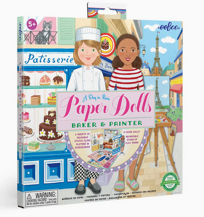 Box of Eeboo’s “Paper Doll Set,” featuring illustrated paper dolls, accessories, and a Paris-themed background—perfect for imaginative play at home or as a unique travel toy. Ages 5+, choking hazard warning visible.