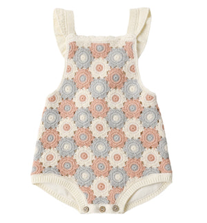 The Rylee & Cru Baby Girls' Crochet Romper features ruffled straps, vintage-inspired cream, pink, and gray circle patterns, is sleeveless, and has convenient snap closures at the bottom.