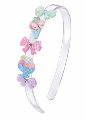 Brighten up your summer parties with the Lillies & Roses Ice Cream Party Bows Headband—made of clear plastic and handcrafted in Brazil, this charming accessory features pastel bows and glittery dessert-shaped accents.