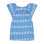 Light blue short-sleeve Girls’ Mini Capucine Caftan by Mer, adorned with white embroidered horizontal patterns and displayed flat against a white background. This lightweight cotton caftan features delicate embroidered detailing for effortless charm.