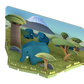 A stylized 3D illustration of a family of blue elephants in a grassy landscape with trees and a distant mountain, inspired by Halftoys Safari Friends.