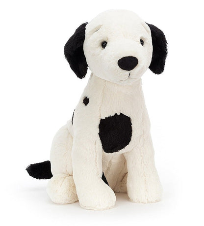 Jellycat Harper Pup, a black and white stuffed dog toy on a white background.