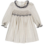 The Kidiwi Baby Girls' and Girls' Hars Organic Cotton Twill Smocked Dress features a cream color, long sleeves, ruffled cuffs, a gathered skirt, and black embroidery on the collar and chest.